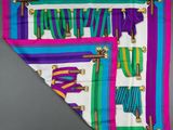 a close up of a colorful scarf hanging on a wall