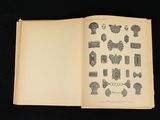 an open book with drawings on it on a black surface