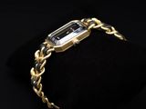 a gold bracelet with an emerald stone on it