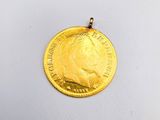 a close up of a gold coin on a white surface