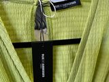 lime green dress hanging on a hanger in a clothing store