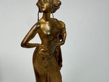 pair of antique bronze figurines of a woman holding a flower