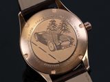a close up of a watch with a picture of a car on it