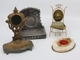 three miniature chairs and a mirror on a white surface