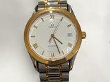 a gold and silver watch with roman numerals on it