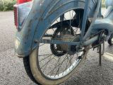 a blue motorcycle parked on the side of the road