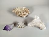 three different types of crystals are displayed on a white surface