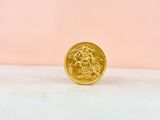 a gold coin sitting on top of a marble counter top