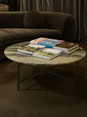 a coffee table with books on top of it in a living room
