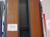 two wooden cabinets in a warehouse with a price tag on them