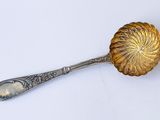 antique silver plated spoon with a flower design on the handle