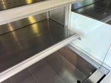 an empty refrigerator in a kitchen with stainless steel counter tops