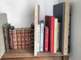 many books that are on a shelf in a room