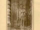 an old photo of a statue of a man in a headdress