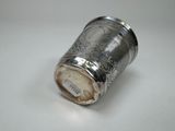 a silver cup that is sitting on a table