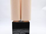 pair of black and white lamps on a black base with a white background