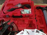 a red box with tools in it on a table