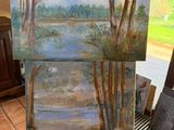 peinture sur chevalet devant un tableau représentant un lac et des arbres
