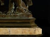 a bronze statue of a man holding a bucket
