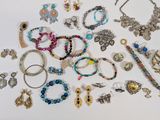 many different types of jewelry on a white surface