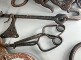 many old rusty scissors hanging on the wall