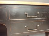 a black dresser with two drawers and a wooden top