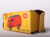 an old red toy truck sitting on top of a cardboard box