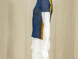 a mannequin wearing a blue and yellow shirt and white pants