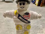 a stuffed toy that is wearing a hat and a sash