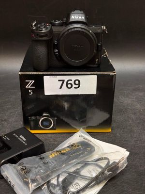 a box with a camera and some other items on the table