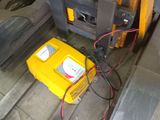 a forklift with a yellow box attached to it