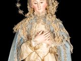 an image of a statue of the virgin mary holding a rosary