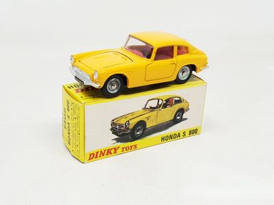 a yellow toy car sitting on top of a box