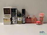 many different types of perfumes sitting on a table