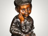 bronze statue of a boy sitting on a stool with his hand on his chin