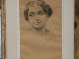 portrait of a woman with a veil on her head in a wooden frame