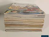 a stack of magazines sitting on a white table