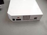 a white projector sitting on a table next to a keyboard
