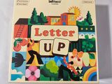a close up of a box of letters up on a table
