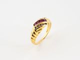 a yellow gold ring with a ruby stone and diamonds