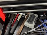 a tool drawer with tools in it on the floor