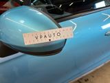 a sticker on the side mirror of a blue car