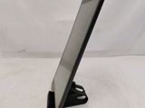 a tablet computer sitting on a stand on a white surface
