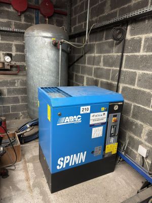 a blue machine that is sitting in the corner of a room