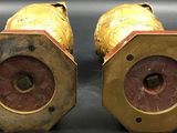 pair of antique brass candlesticks with red and gold paint