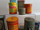 many tins on display on a shelf in a room