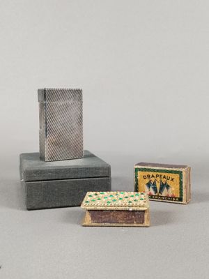 two matches and a box of matches are sitting on a table