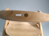 a wooden chair that has a surfboard on top of it