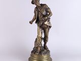 an old bronze statue of a man with a dog on a pedestal