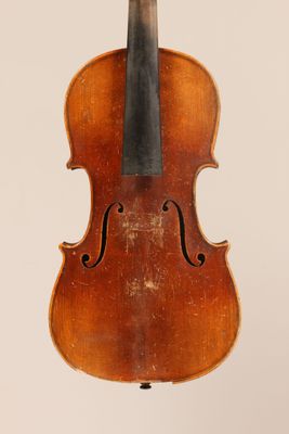 an old violin with a bow hanging from it ' s back